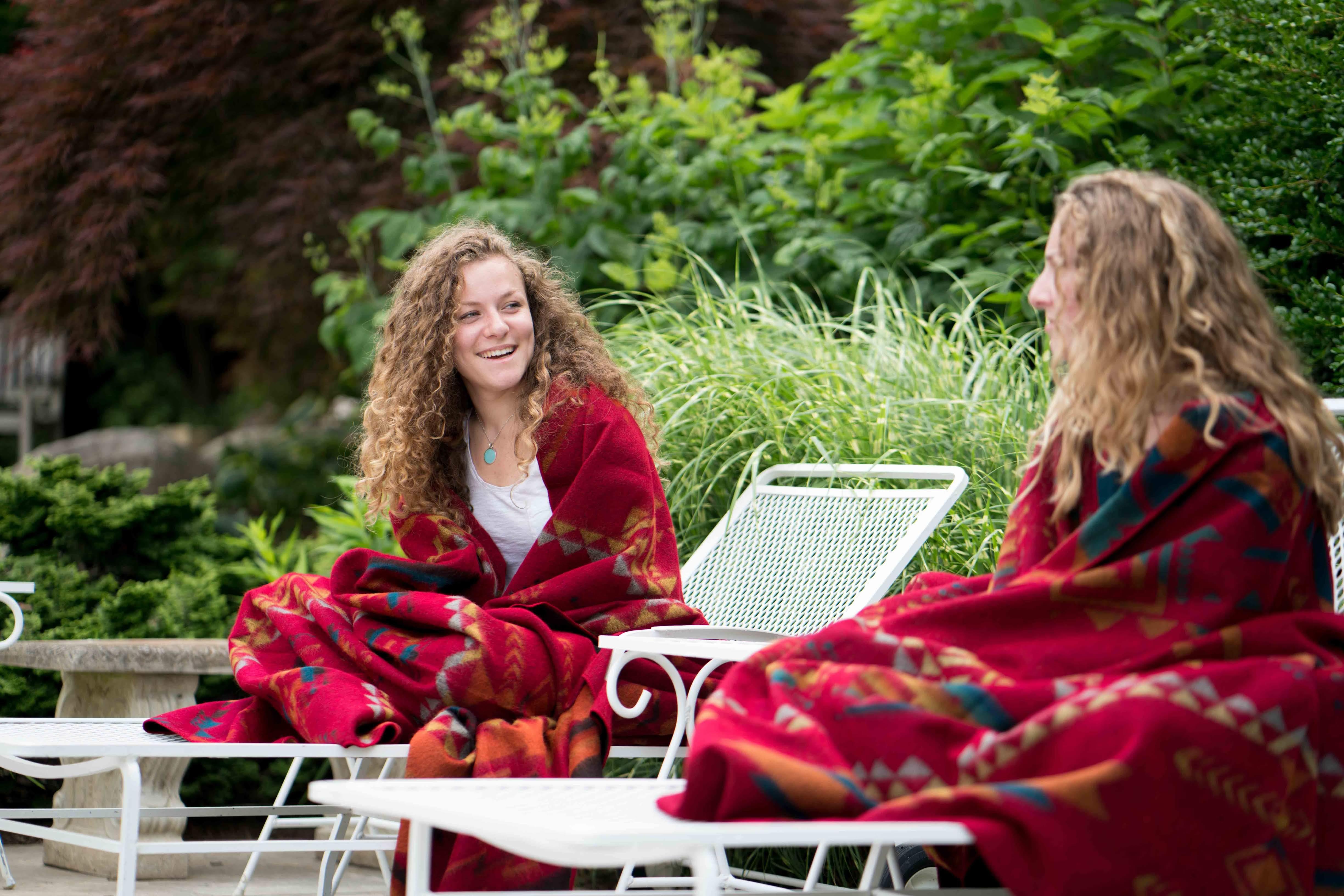 Girls using Corazon Wildfire Southwestern Queen Blanket in red and patterns - Your Western Decor