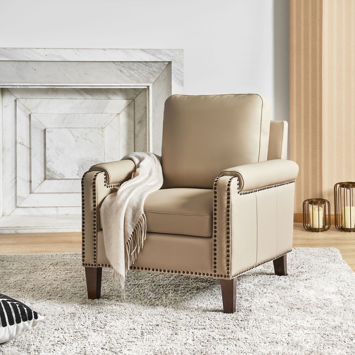 Carson Ivory leather accent chair with nailhead trim styled in a bright living room with fireplace and neutral decor