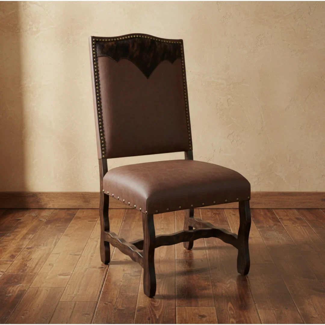 Brown leather chair with wooden legs on a wooden floor against a beige wall.