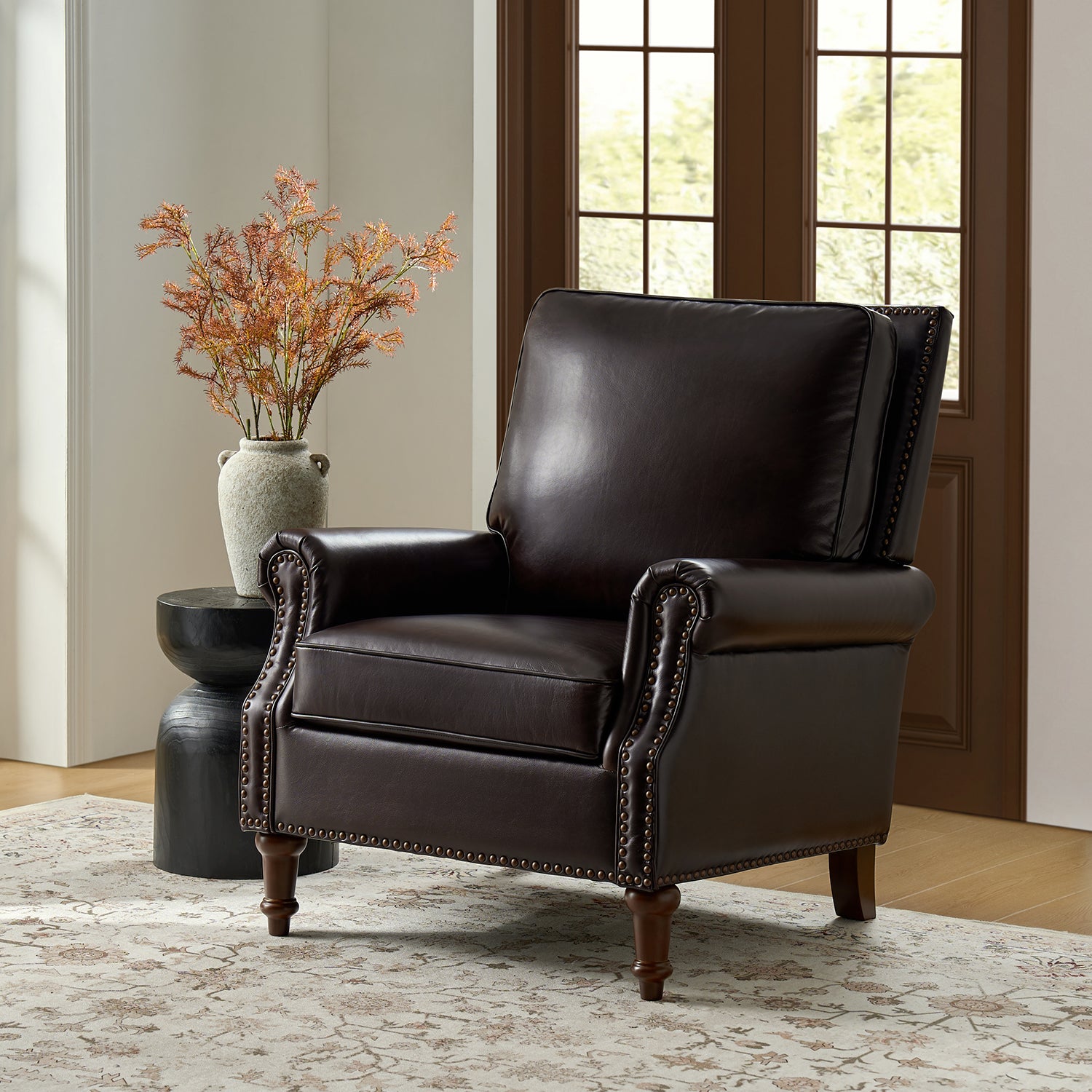 Espresso Canyon dark brown leather chair styled in living room with fireplace, neutral rug and modern accent table