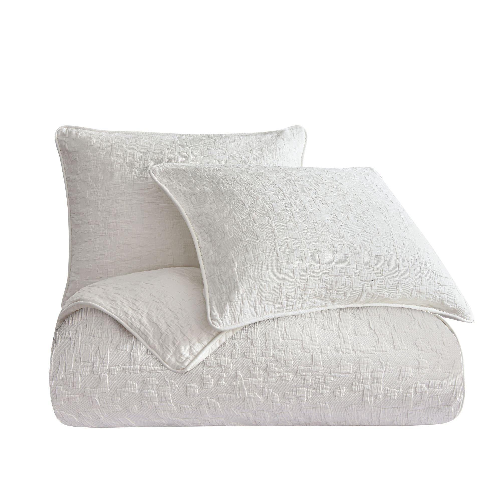 White textured comforter and pillow on a white background