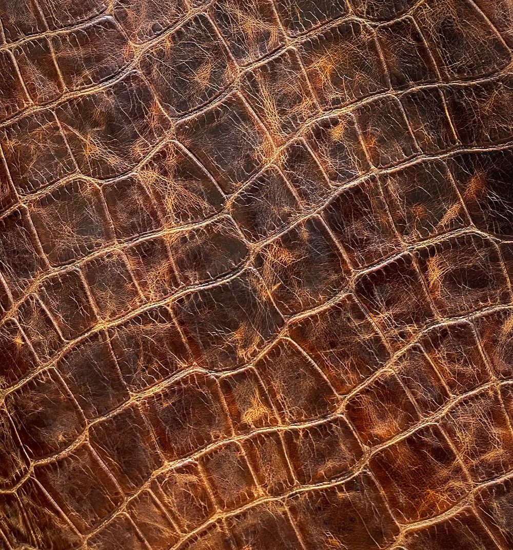 Close up of jumbo croc leather in caramel distressed brown