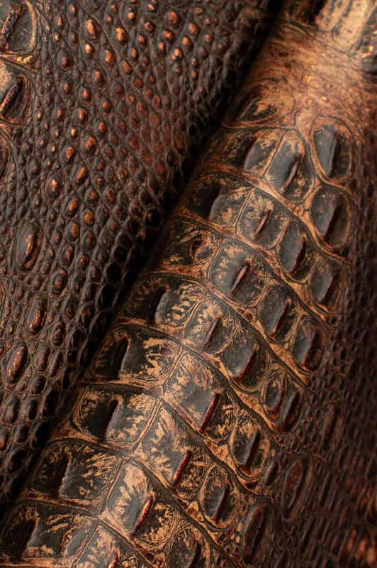 Detail of two-tone croc embossed leather with metallic hints