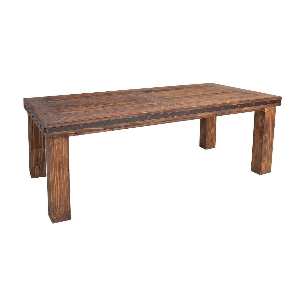 A rustic rectangular wooden dining table with a medium brown finish, featuring dark metal rivet detailing along the apron and legs, shown on a plain white background.