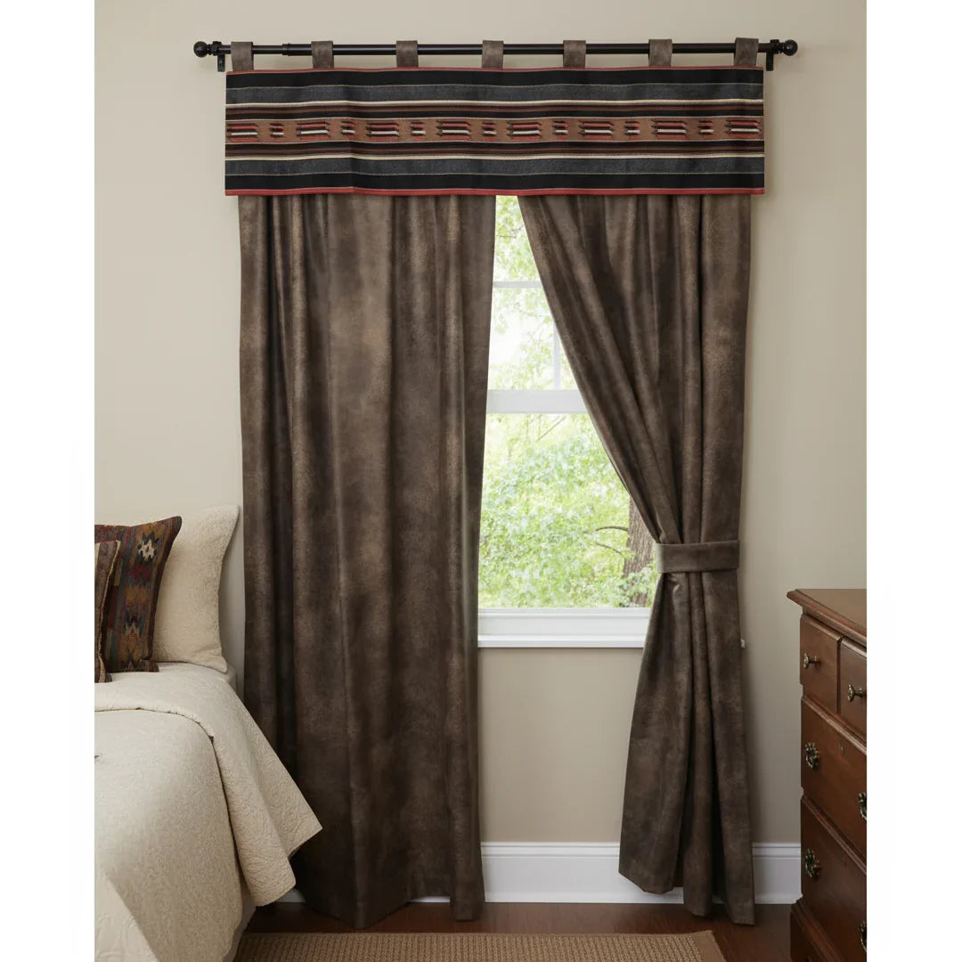 Brown curtains with decorative valance in a room with a bed and dresser.