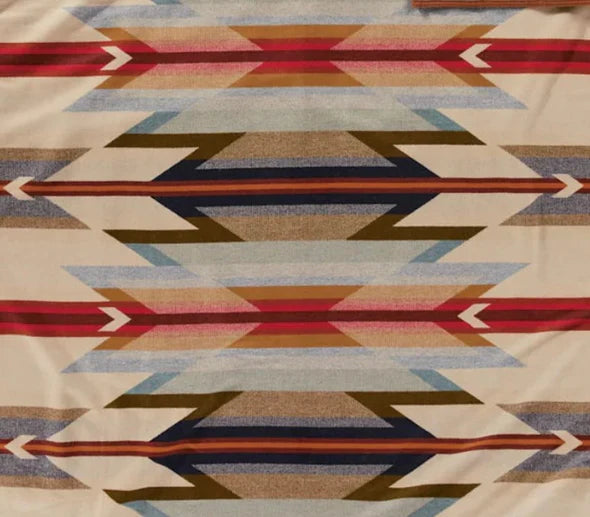 Authentic Pendleton® Wyeth Trails fabric featuring a Southwestern geometric pattern in ivory, red, blue, tan, and brown inspired by classic Western design.