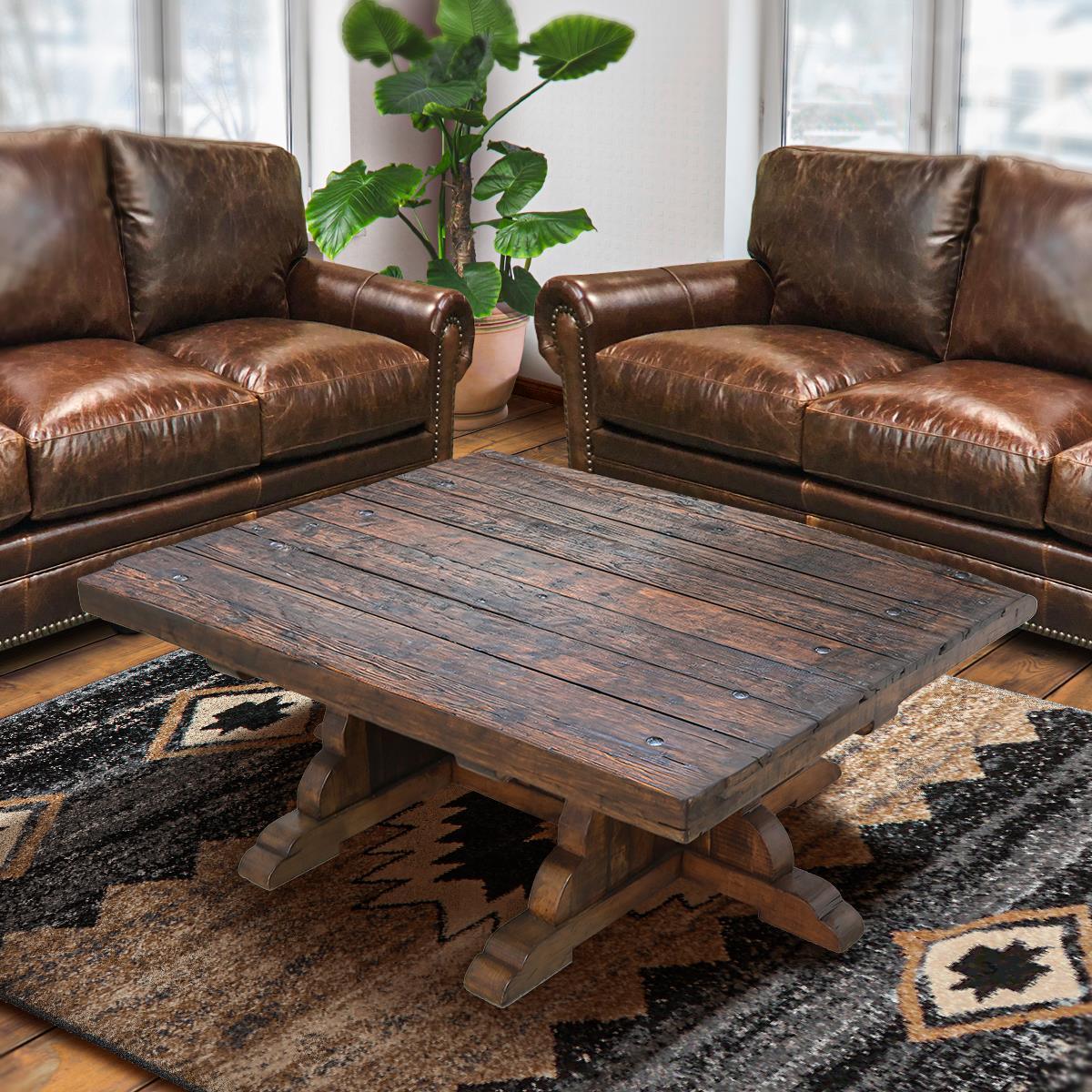 Brown leather sofas with a wooden coffee table in a living room setting - Your Western Decor