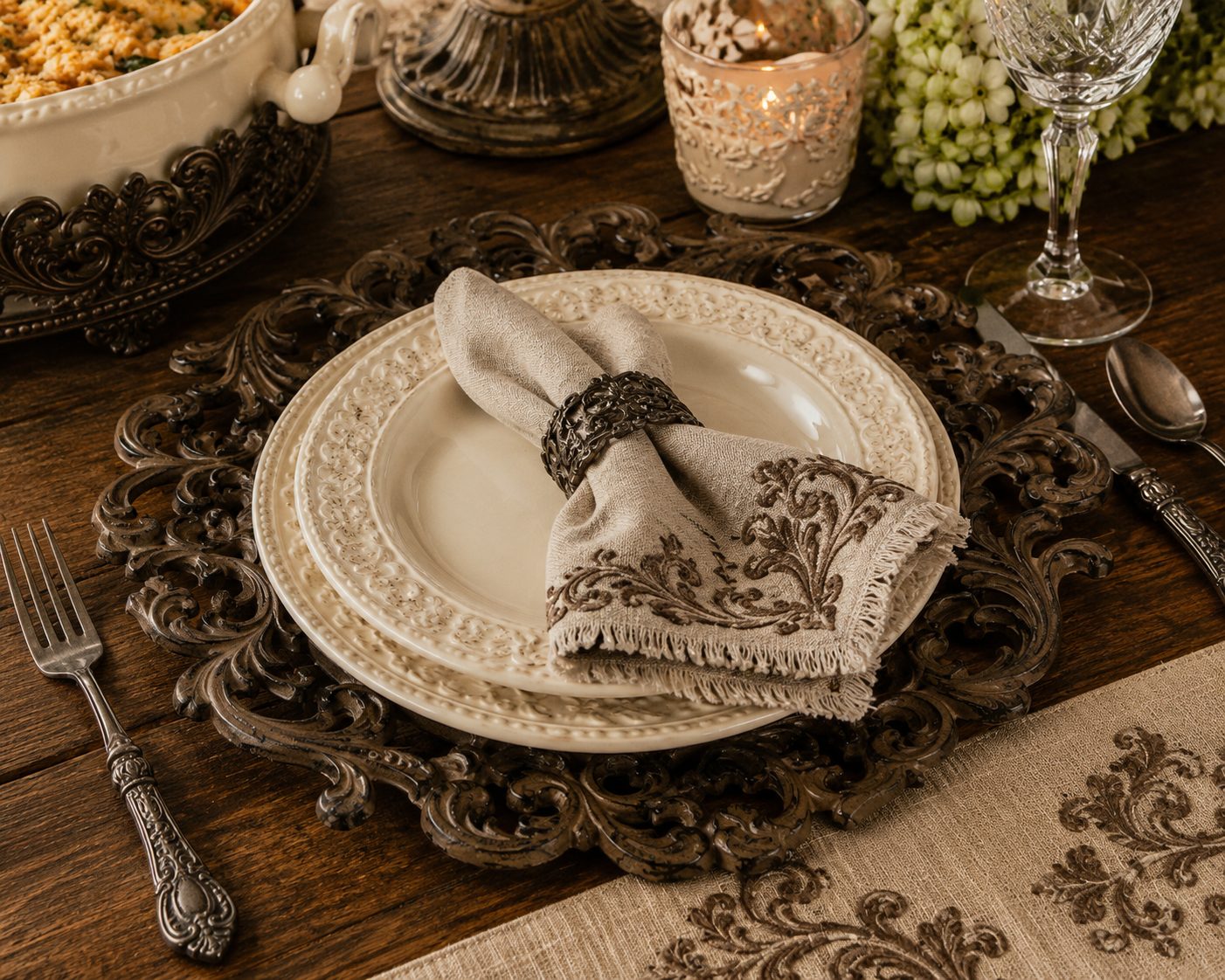 Acanthus Estate charger plate styled beneath cream stoneware dinnerware on a rustic dining table.