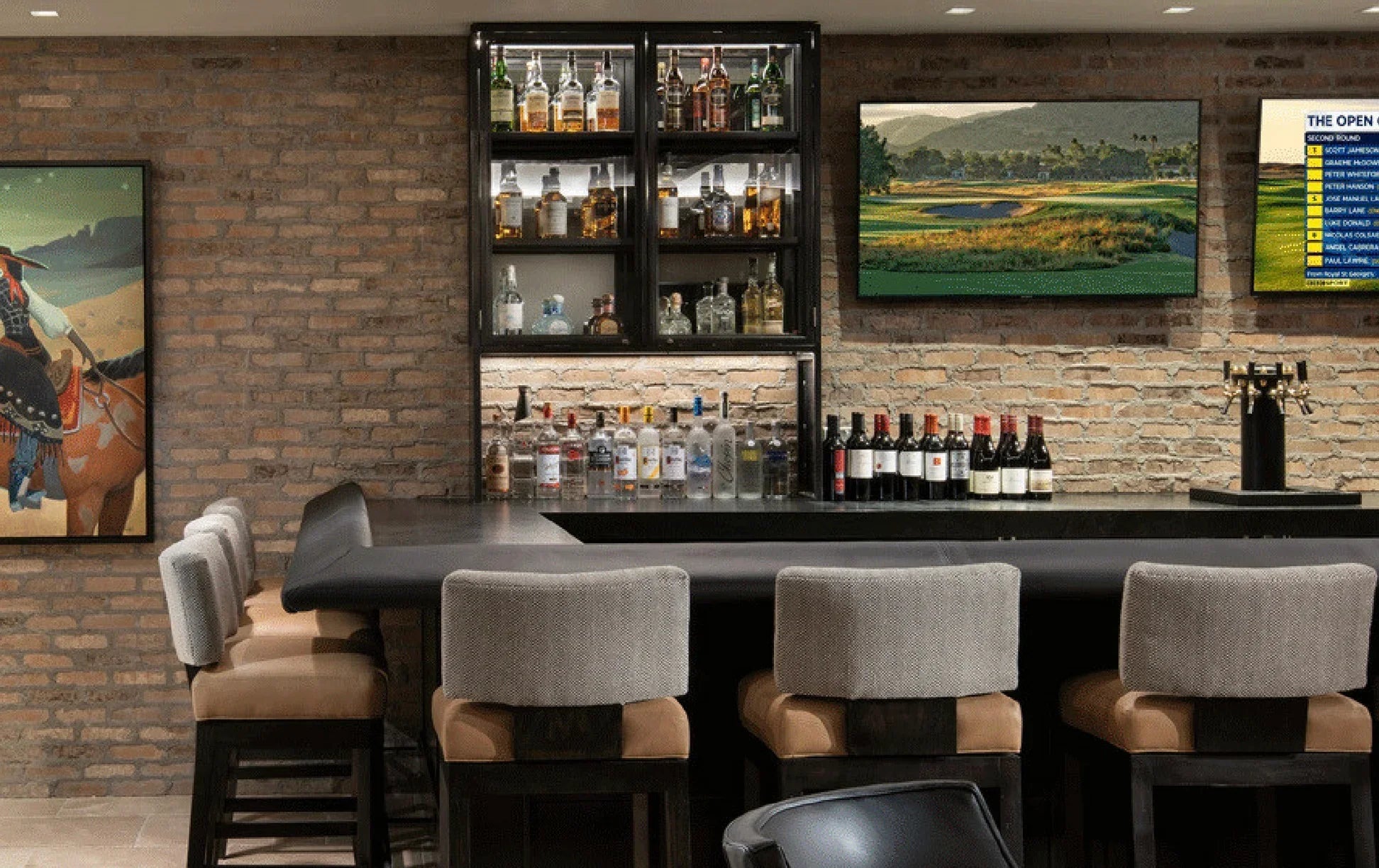 Andes bar chairs in bar area with shelves stocked with bottles, a painting on the wall, and a television displaying a golf course - Your Western Decor