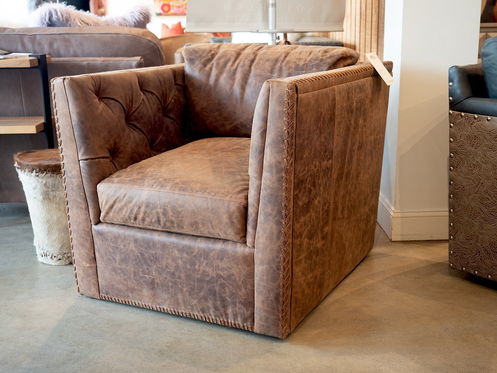 distressed top grain leather western swivel chair with hand tailored stitching and rustic ranch design