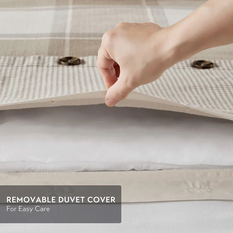 Hand lifting a removable duvet cover to show ease of care, with text 'Removable Duvet Cover For Easy Care' on a neutral background - Your Western Decor