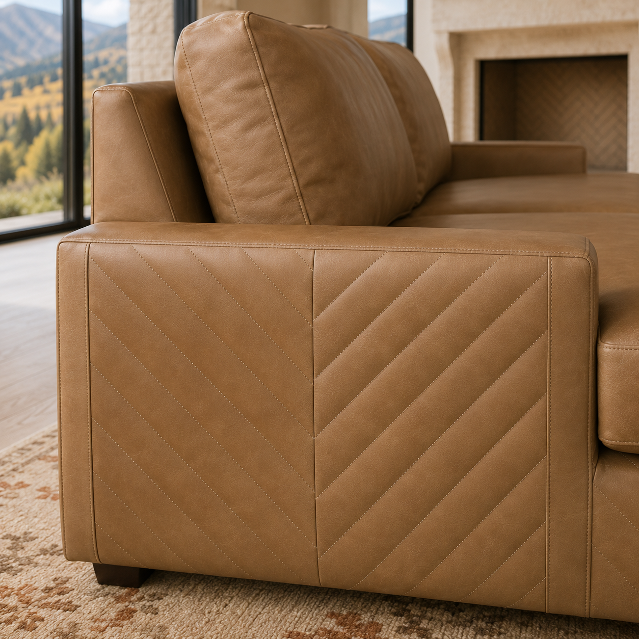 A close-up of a tan brown leather sofa showing the quilted side panel and back cushions in a modern living room setting.