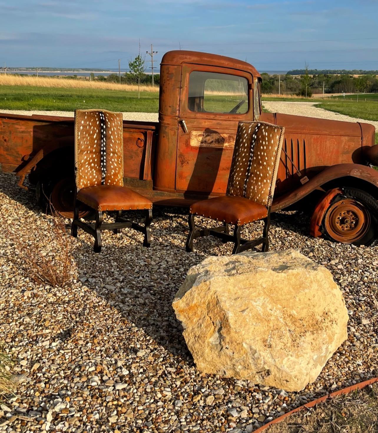 Rustic truck with wooden chairs on a gravel surface - Your Western Decor