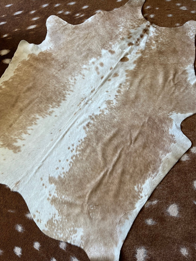 Beige with white backbone cowhide rug