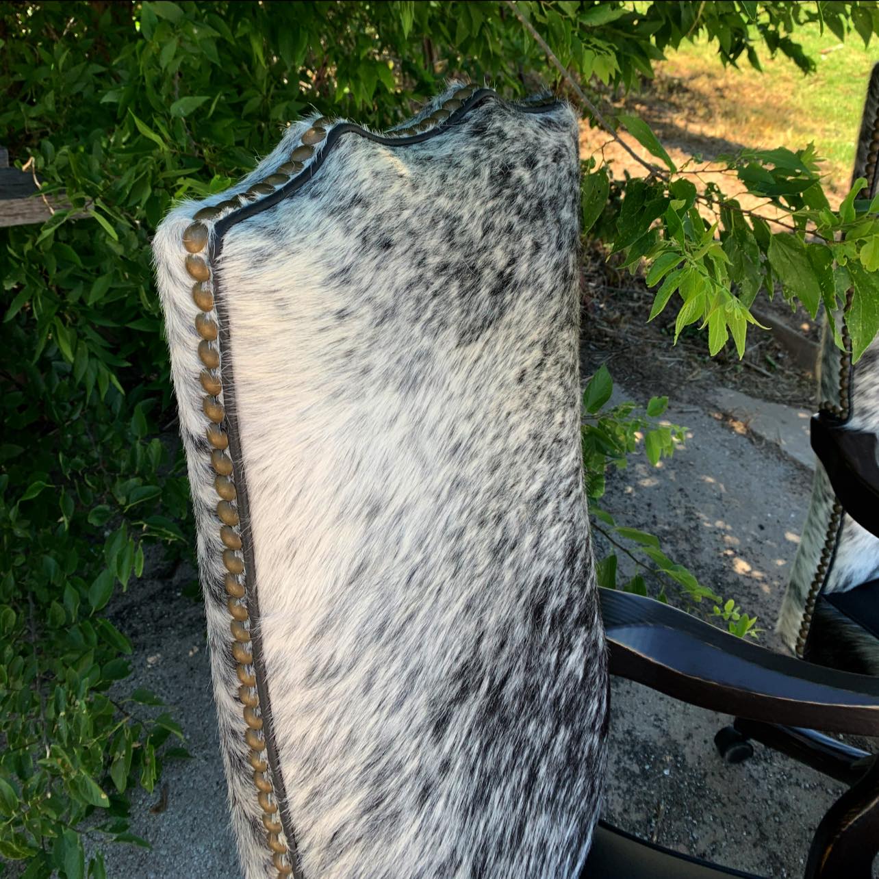 Peppered cowhide office chair seat back nail trim detail