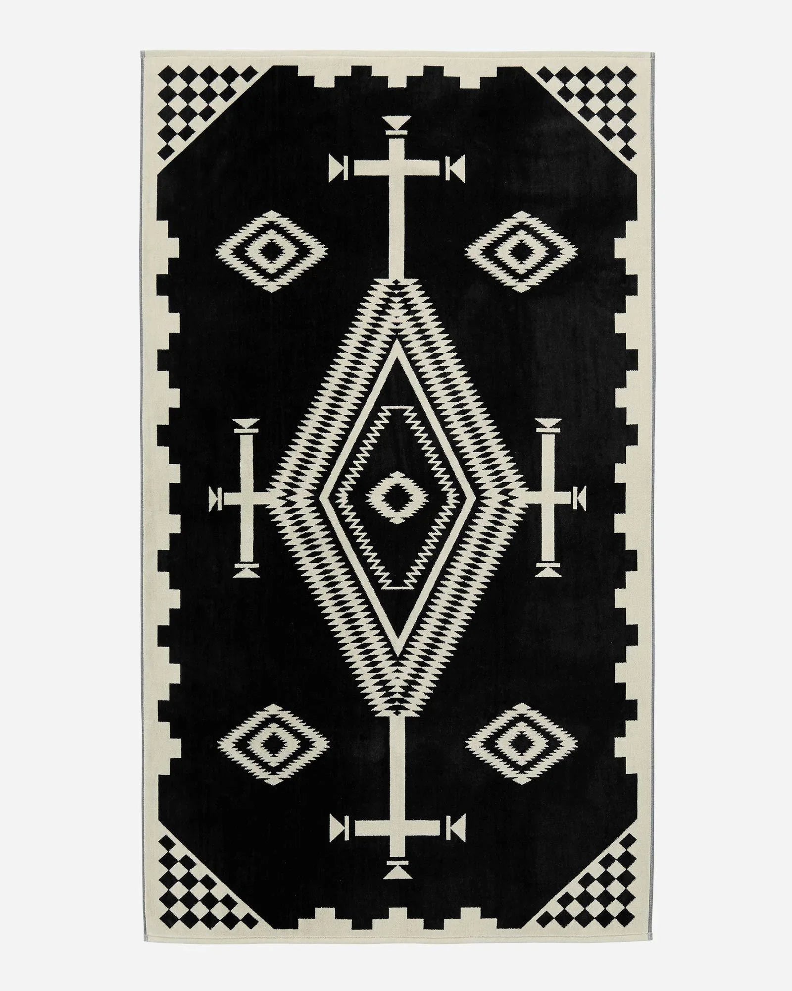 Pendleton Los Ojos Spa & Beach Towel woven from premium cotton velour featuring a bold black and ivory Southwestern-inspired pattern.