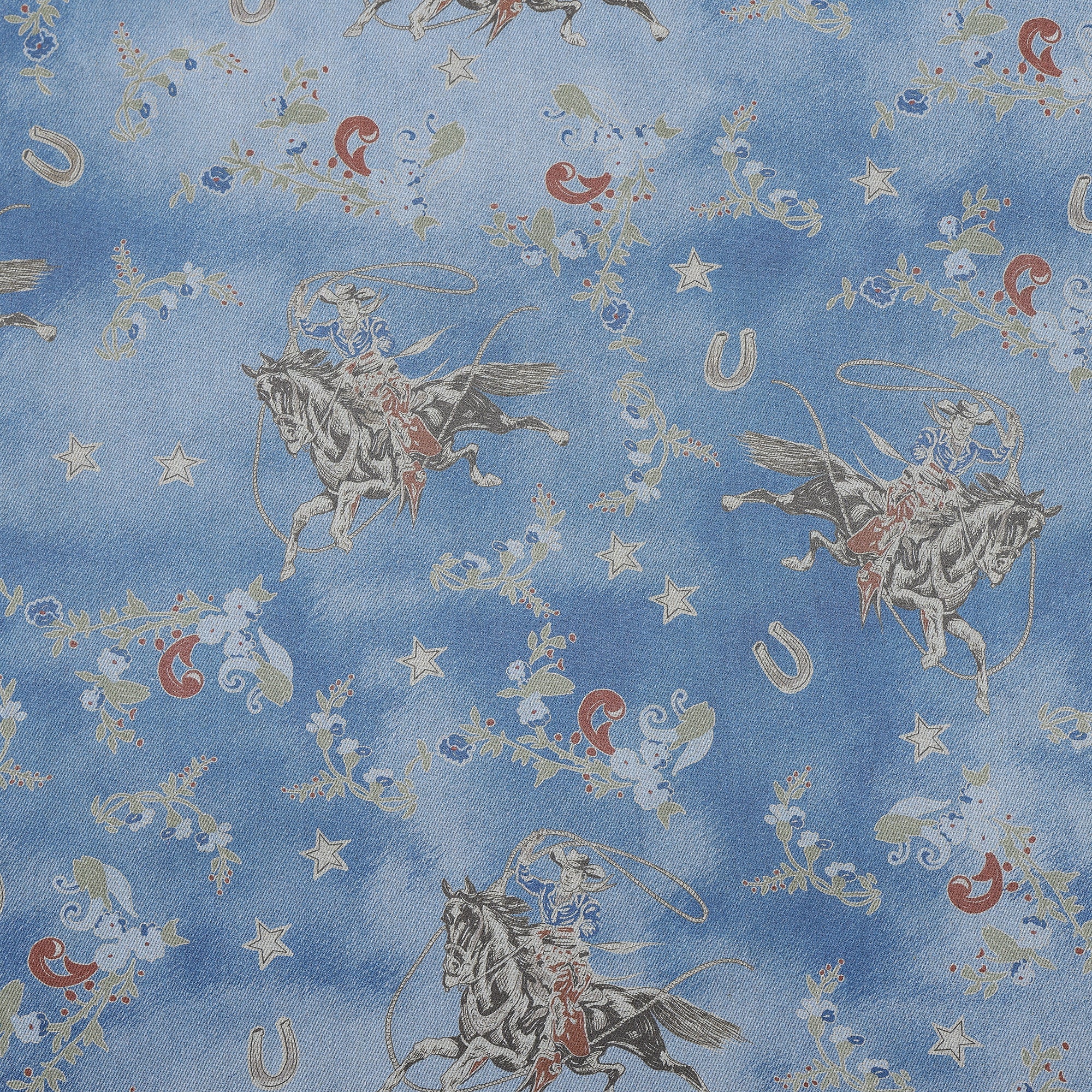 Patterned fabric with cowboy and horse design on a blue background