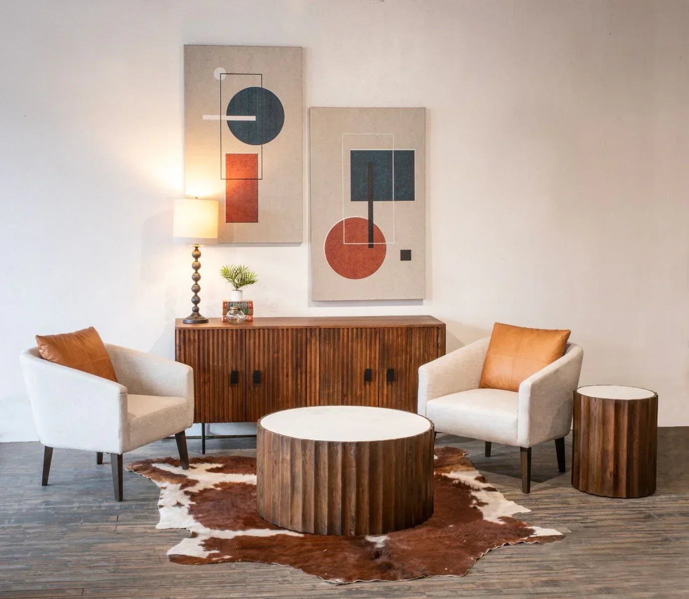 Boho living room with wooden furniture, round coffee table, and abstract art on the wall - Your Western Decor