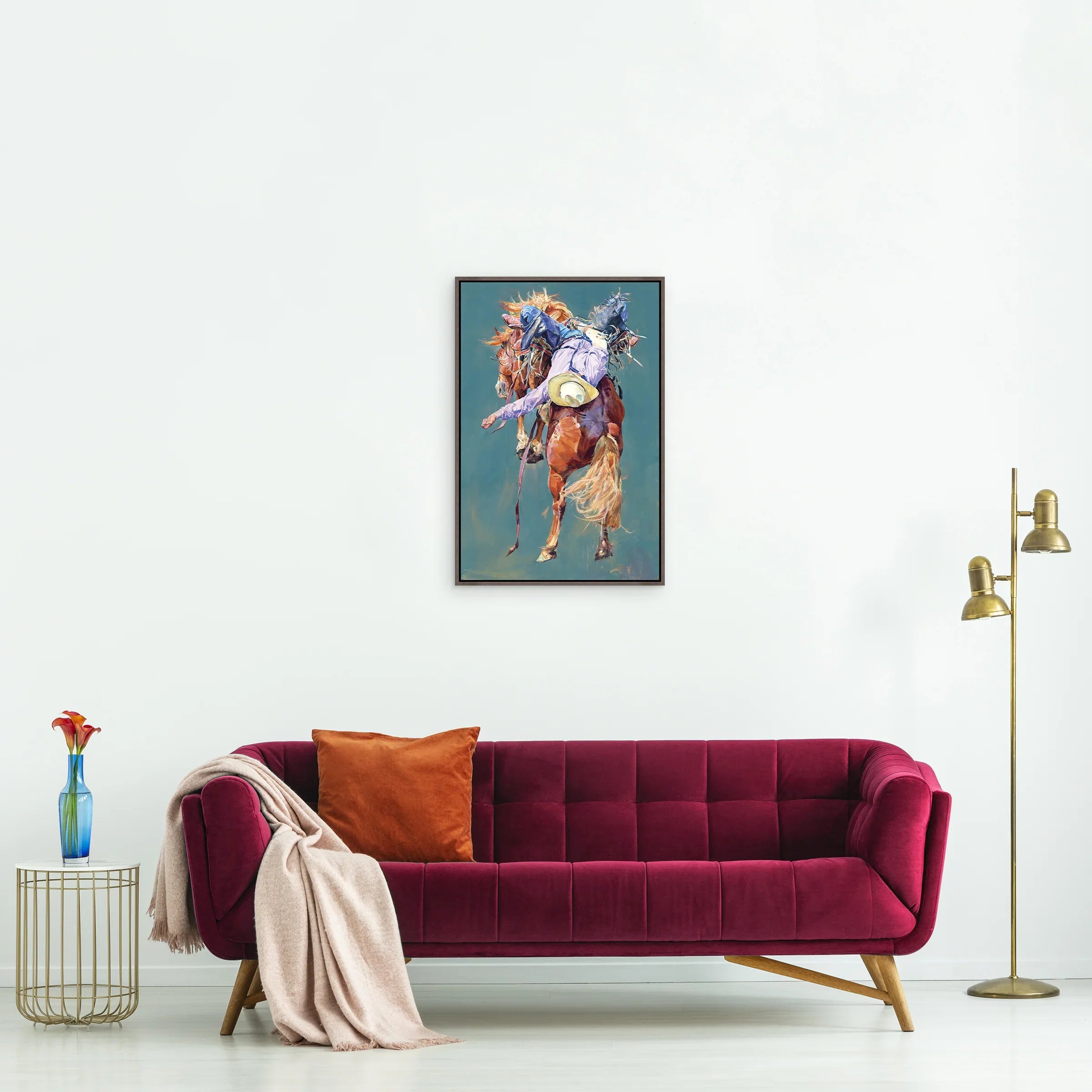 Rodeo bronc art over red sofa - Your Western Decor