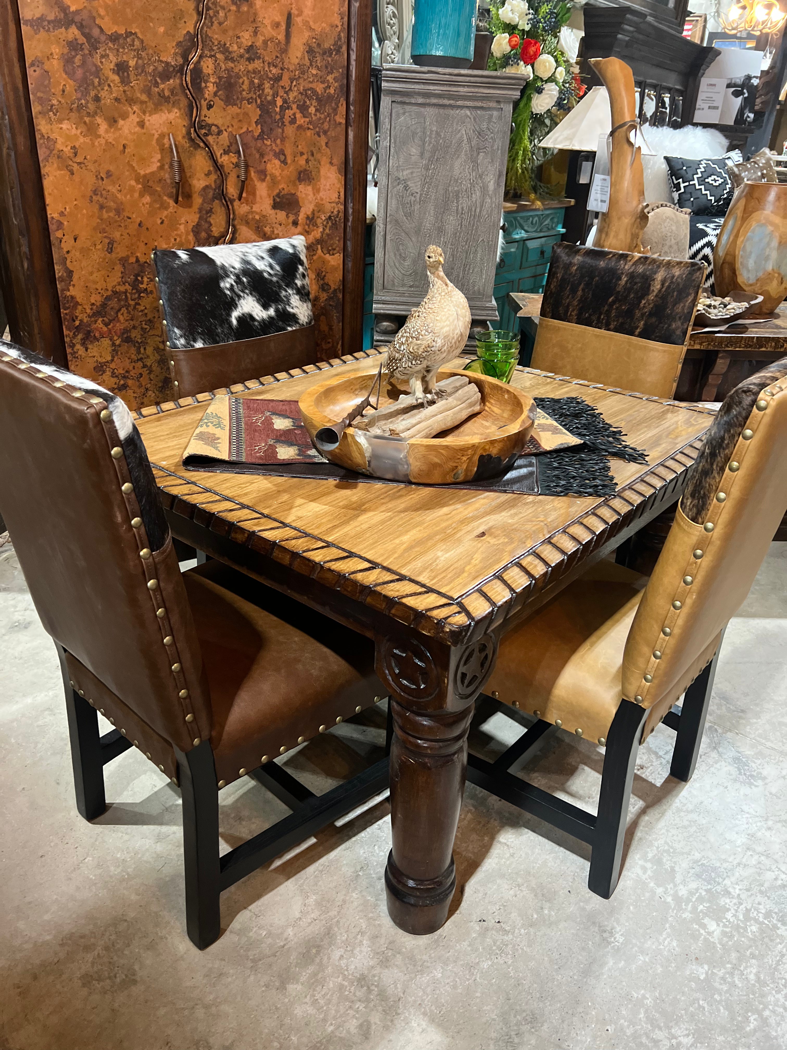 Brooks leather and cowhide custom dining chairs set at western table - Your Western Decor