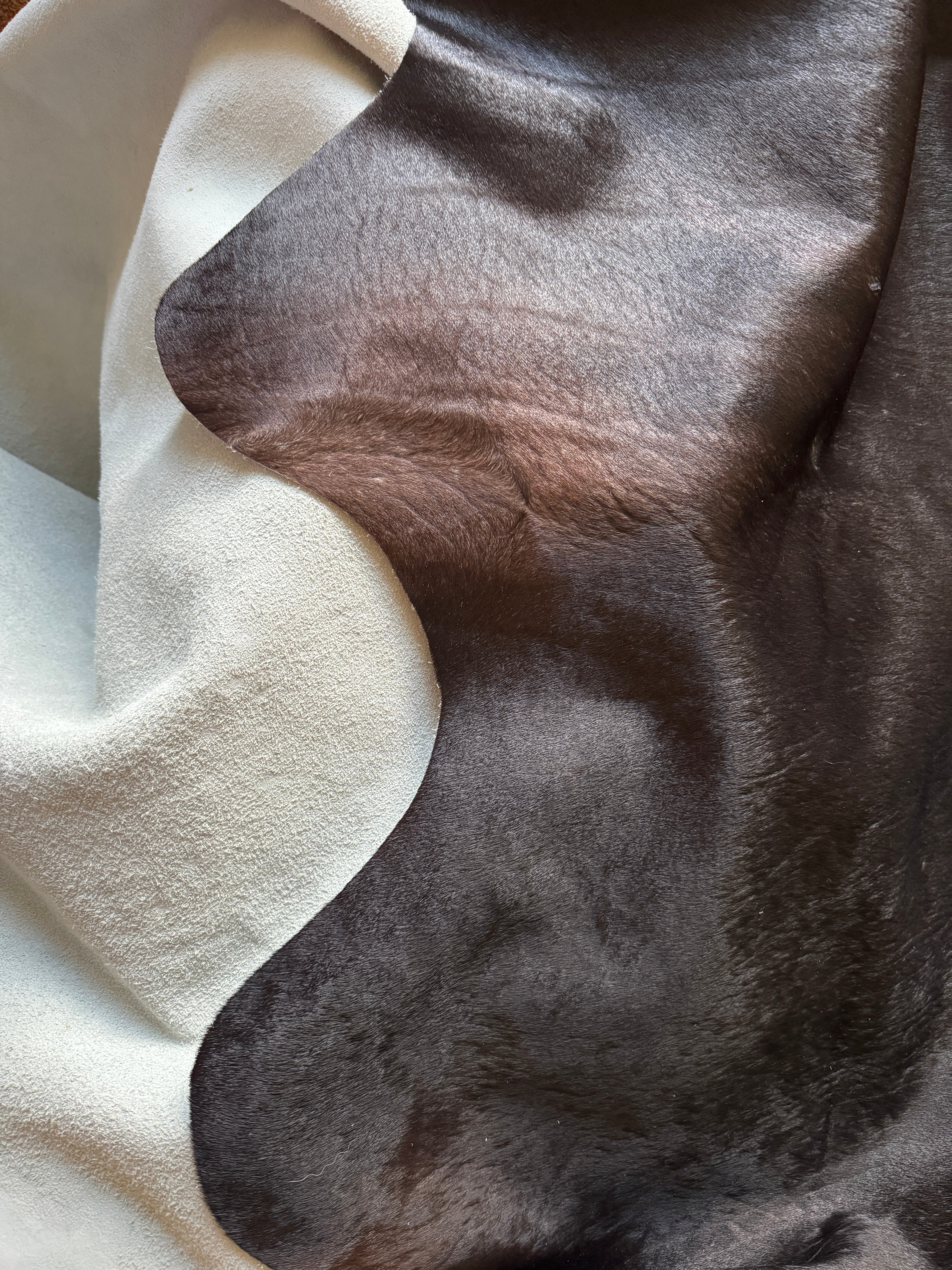 Brown undertones in black cowhide rug