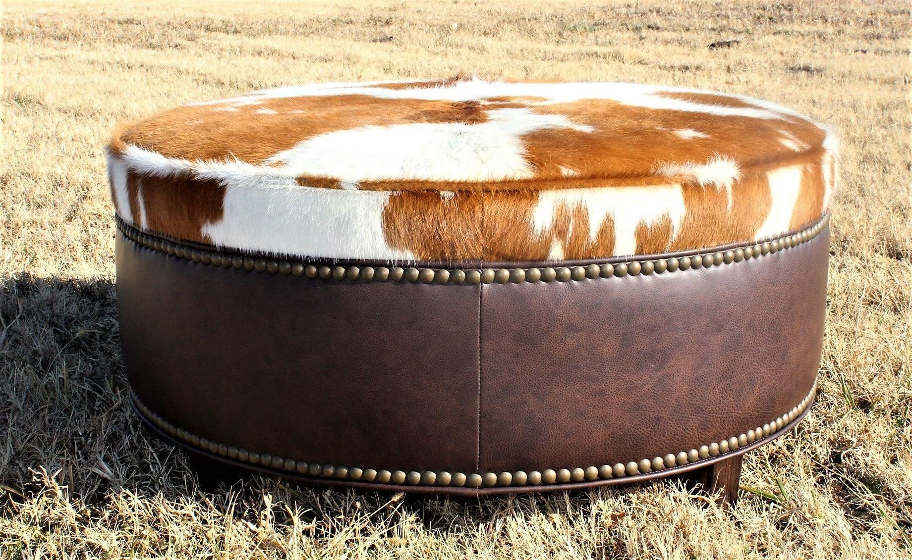 western ottoman with cowhide top and leather base nailhead trim