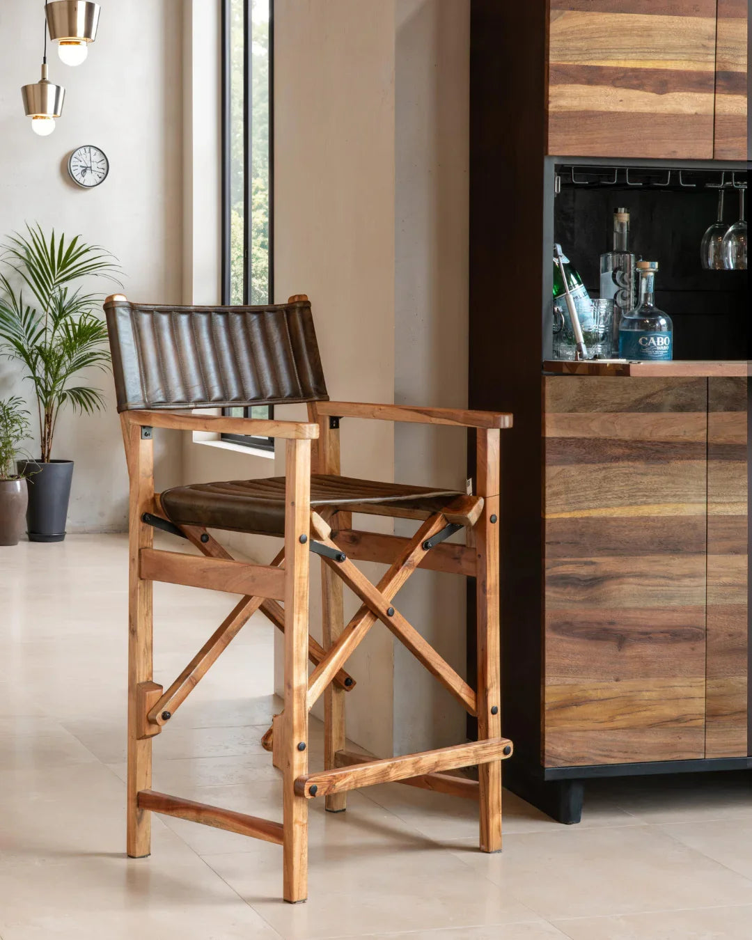 Wooden director's chair in a kitchen setting with a wooden cabinet and plants - Your Western Decor