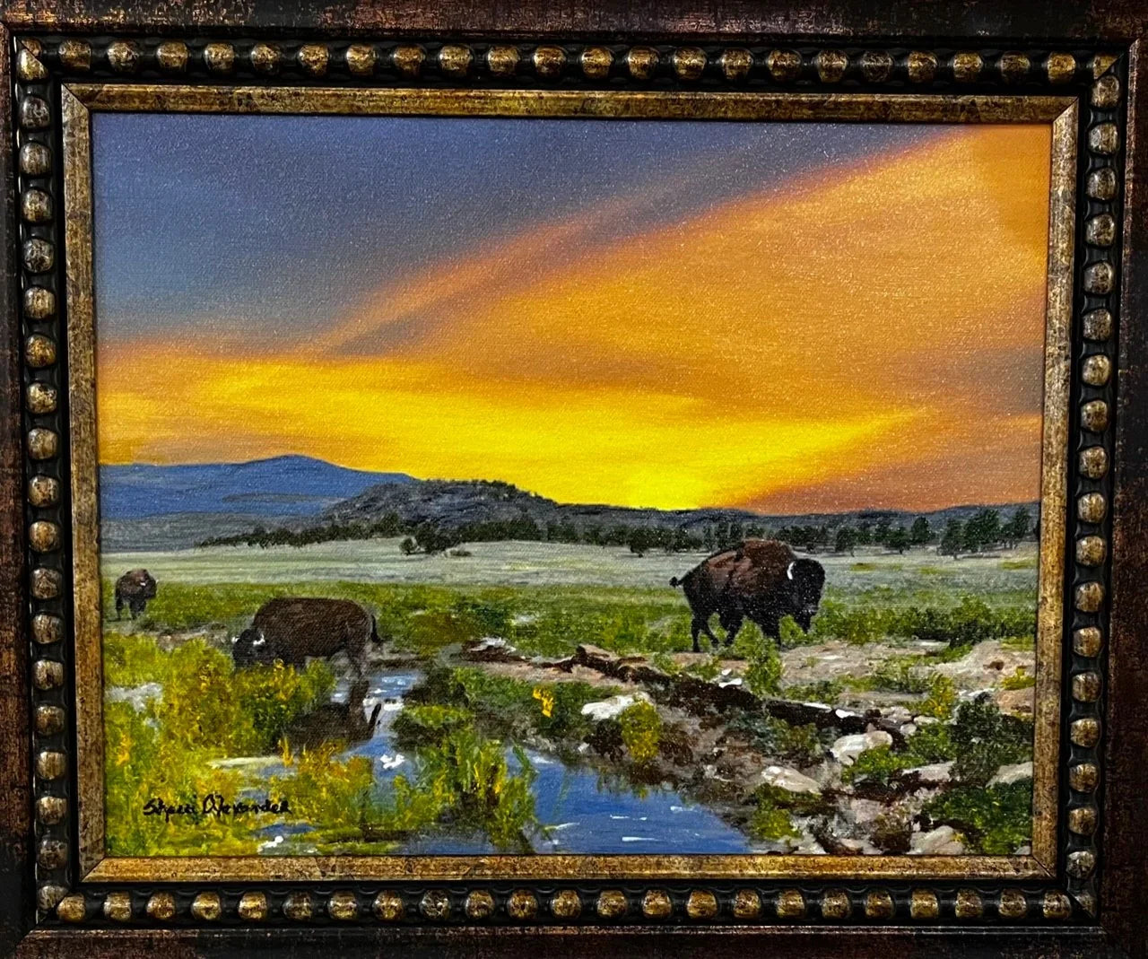 Painting of bison in a field with a sunset sky, framed in gold. Art by Sherri Alexander - Your Western Decor
