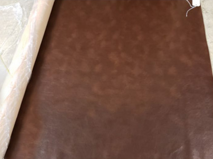 brown western canteen faux leather fabric on the roll