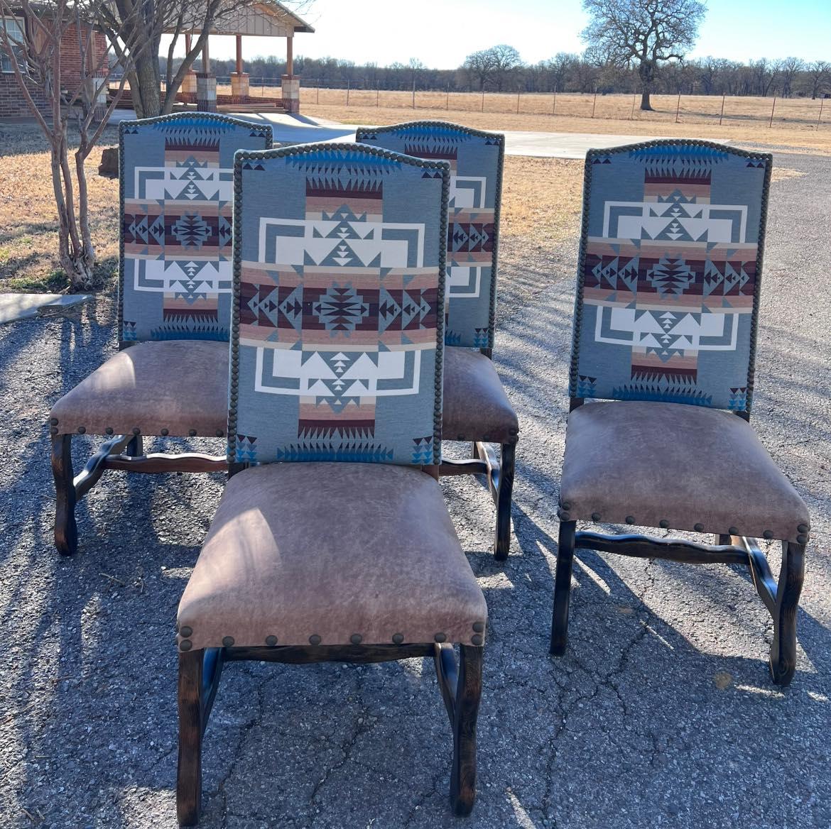 Four chairs with patterned backrests on a cracked pavement surface - Your Western Decor