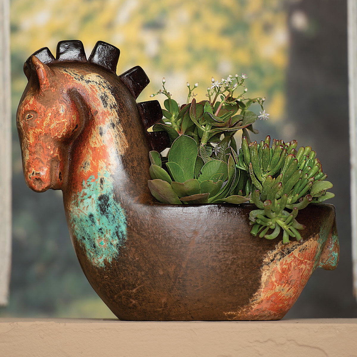 Decorative horse-shaped clay planter with succulents against a blurred natural background - Your Western Decor