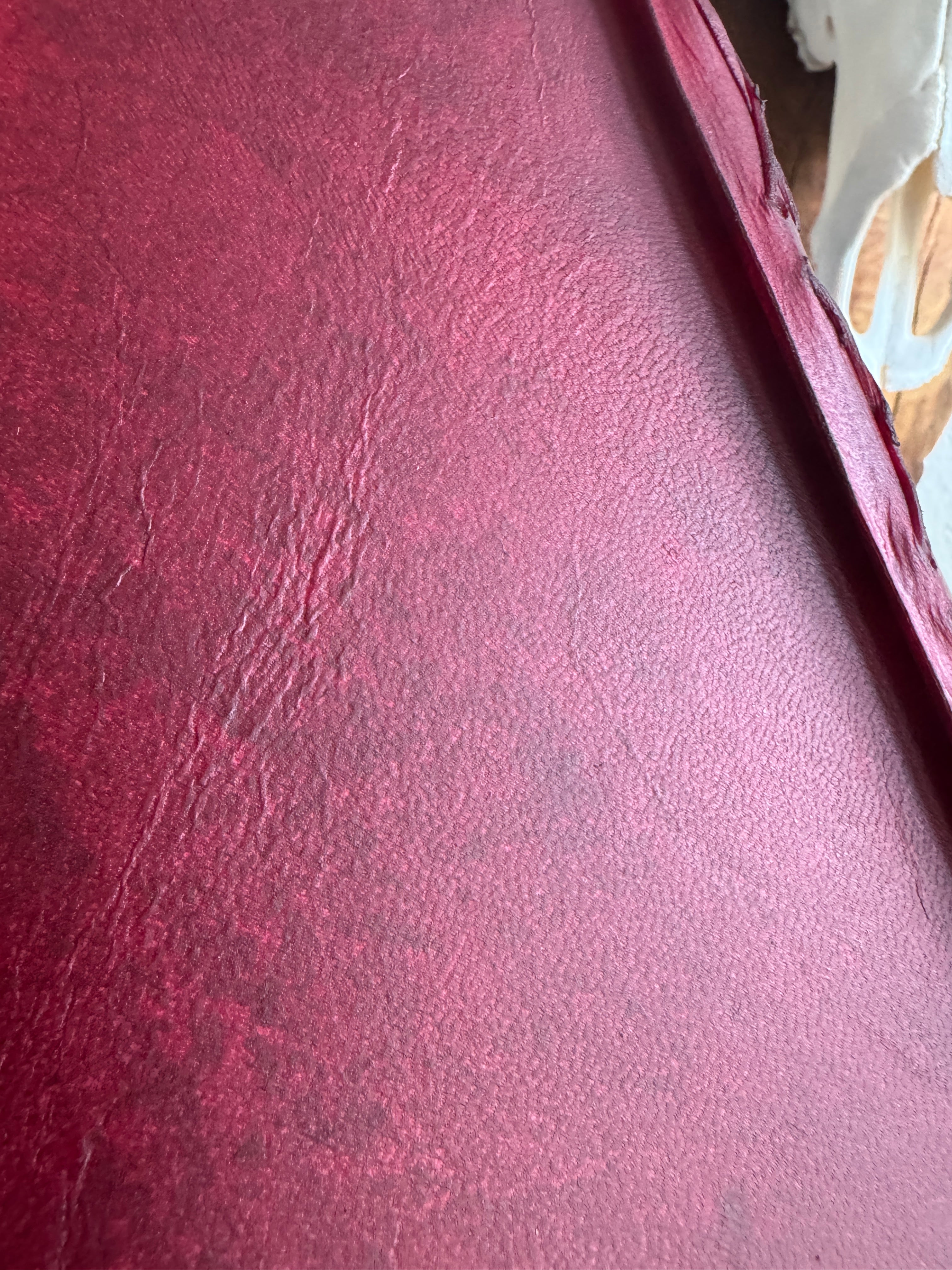 Close up of red rawhide on round leather lamp shade