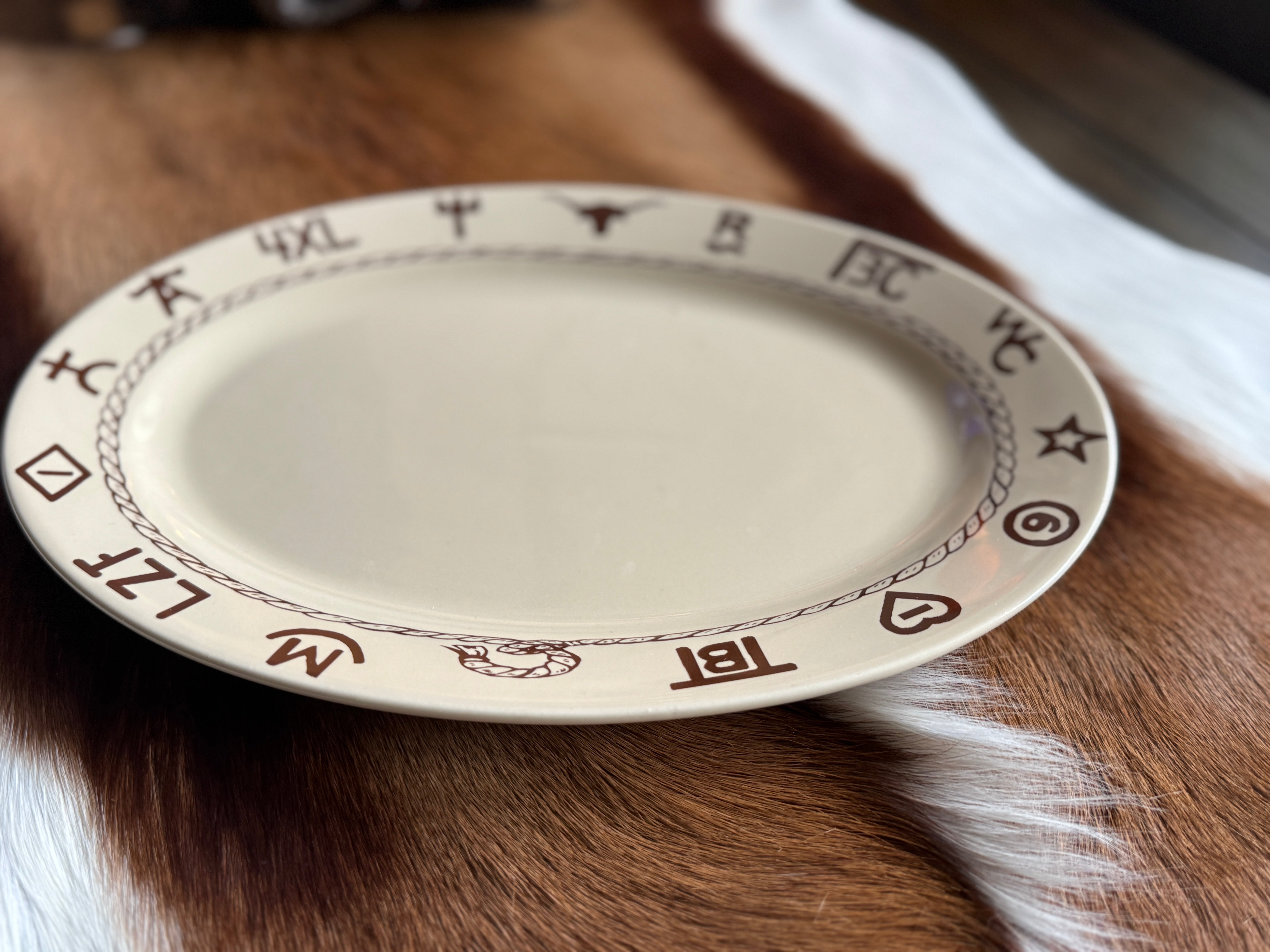 Oval beige steak plate with ranch brands in dark brown