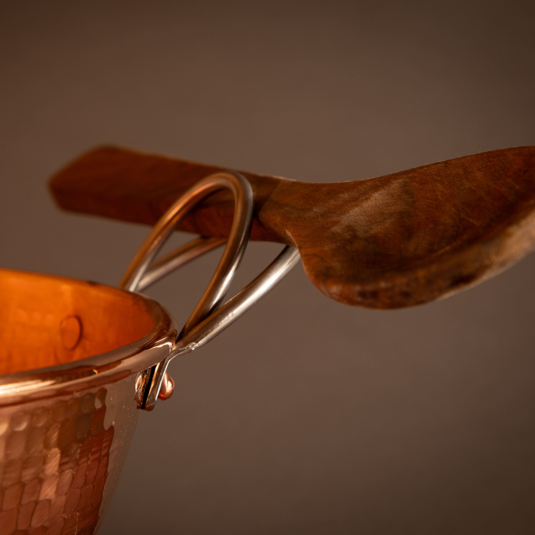 Hammered copper mixing bowl with spoon holding handle feature