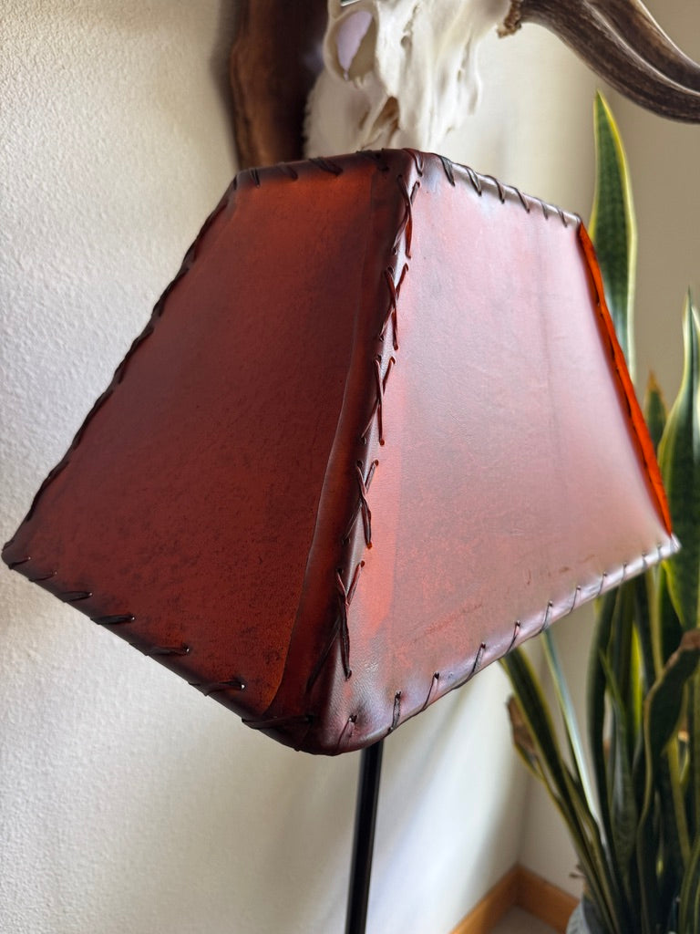 Detail of whip stitching on amber rawhide lamp shade