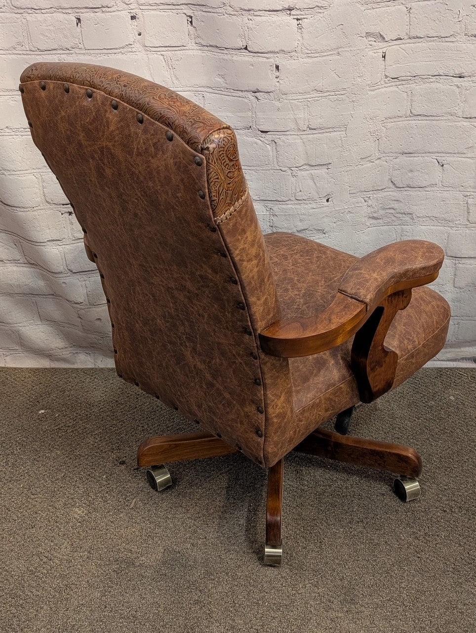 Back view of distressed leather western desk chair