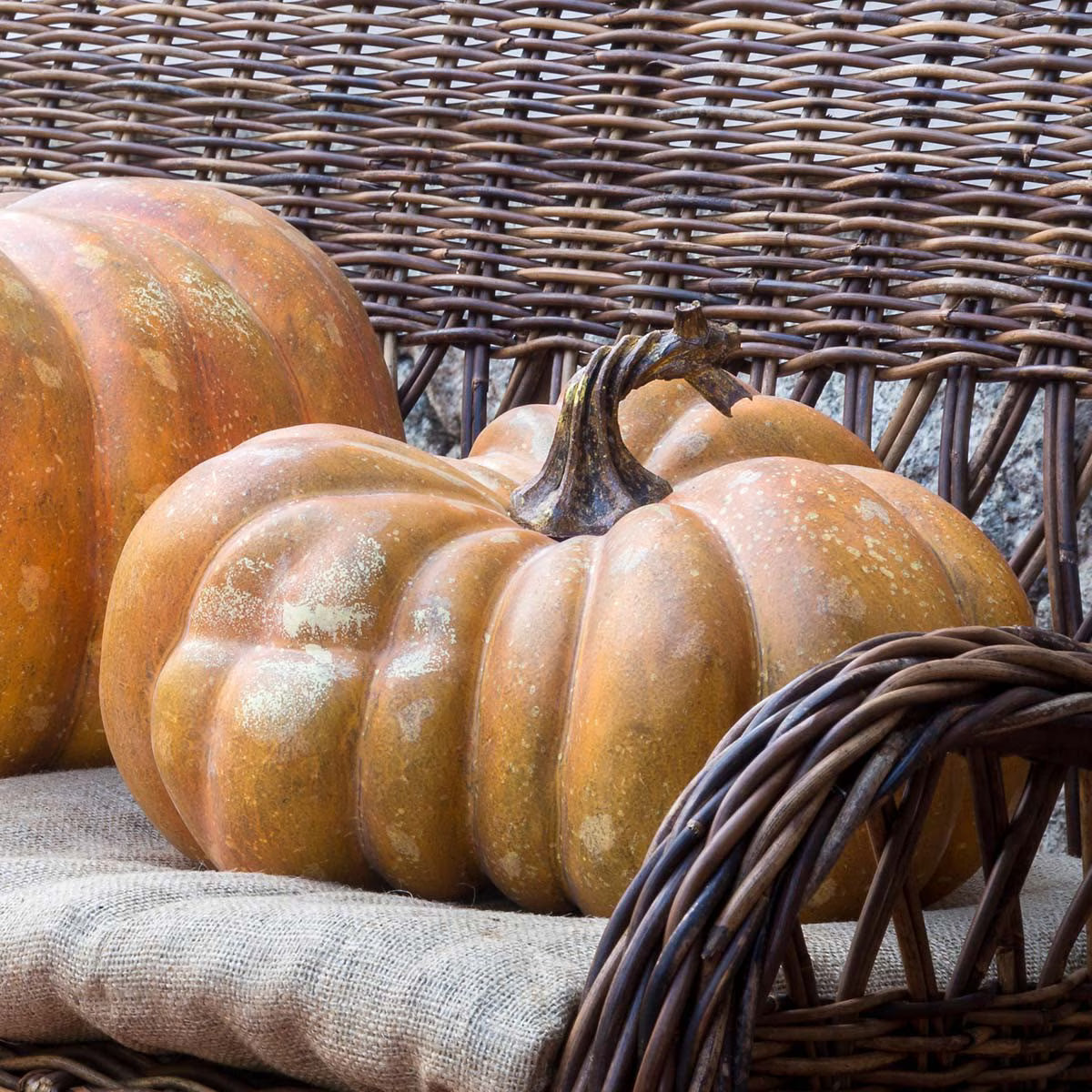Faux fall pumpkins on wicker sofa - Your Western Decor