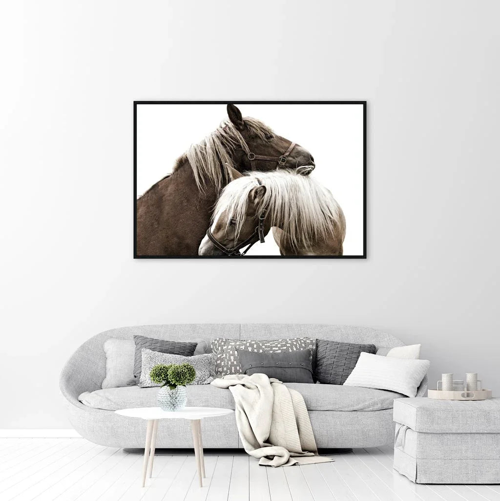 Framed artwork of two horses embracing on a white wall above a gray sofa - American made art - Your Western Decor