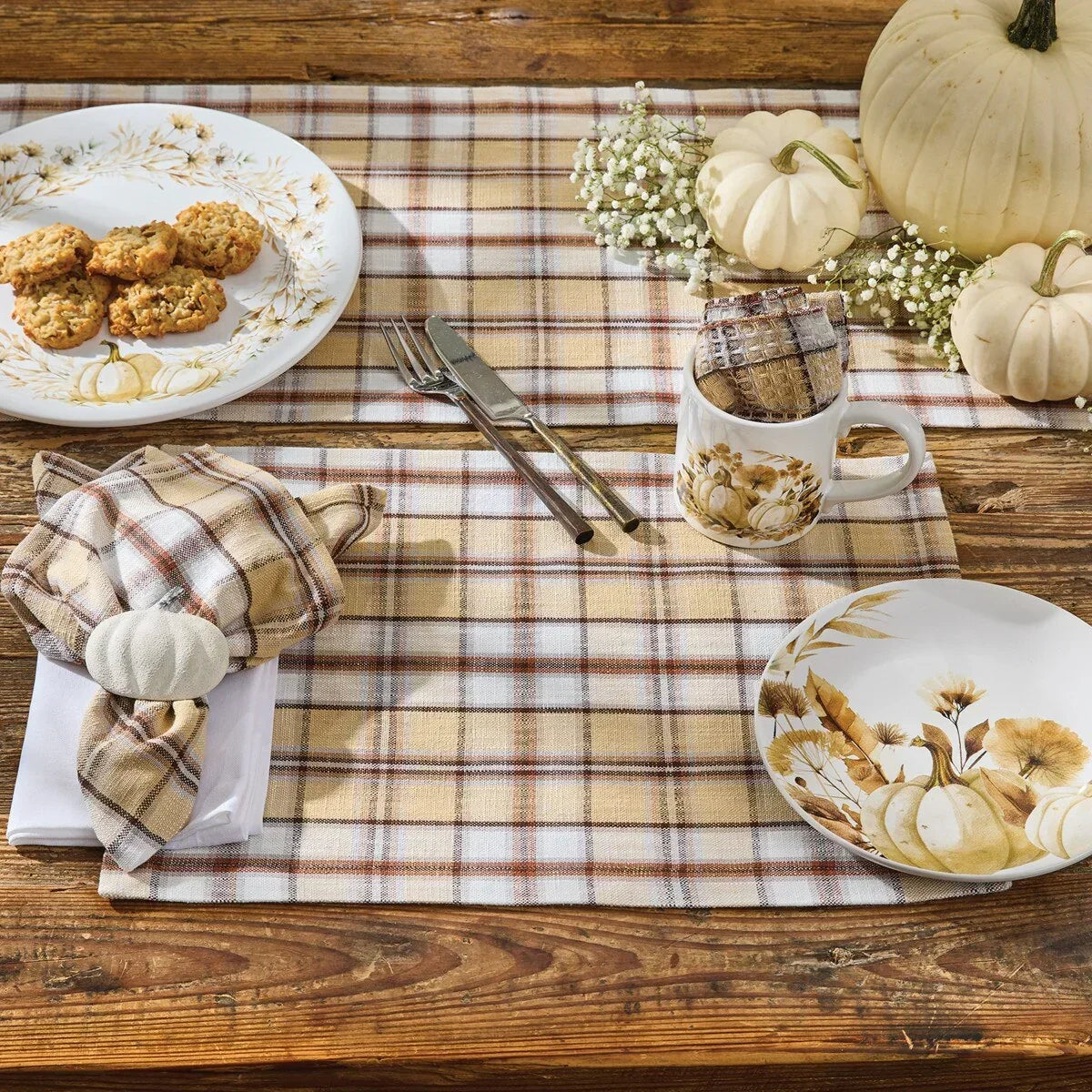 Thanksgiving table setting with plaid placemats, pumpkins, and fall-themed plates on a wooden table - Your Western Decor