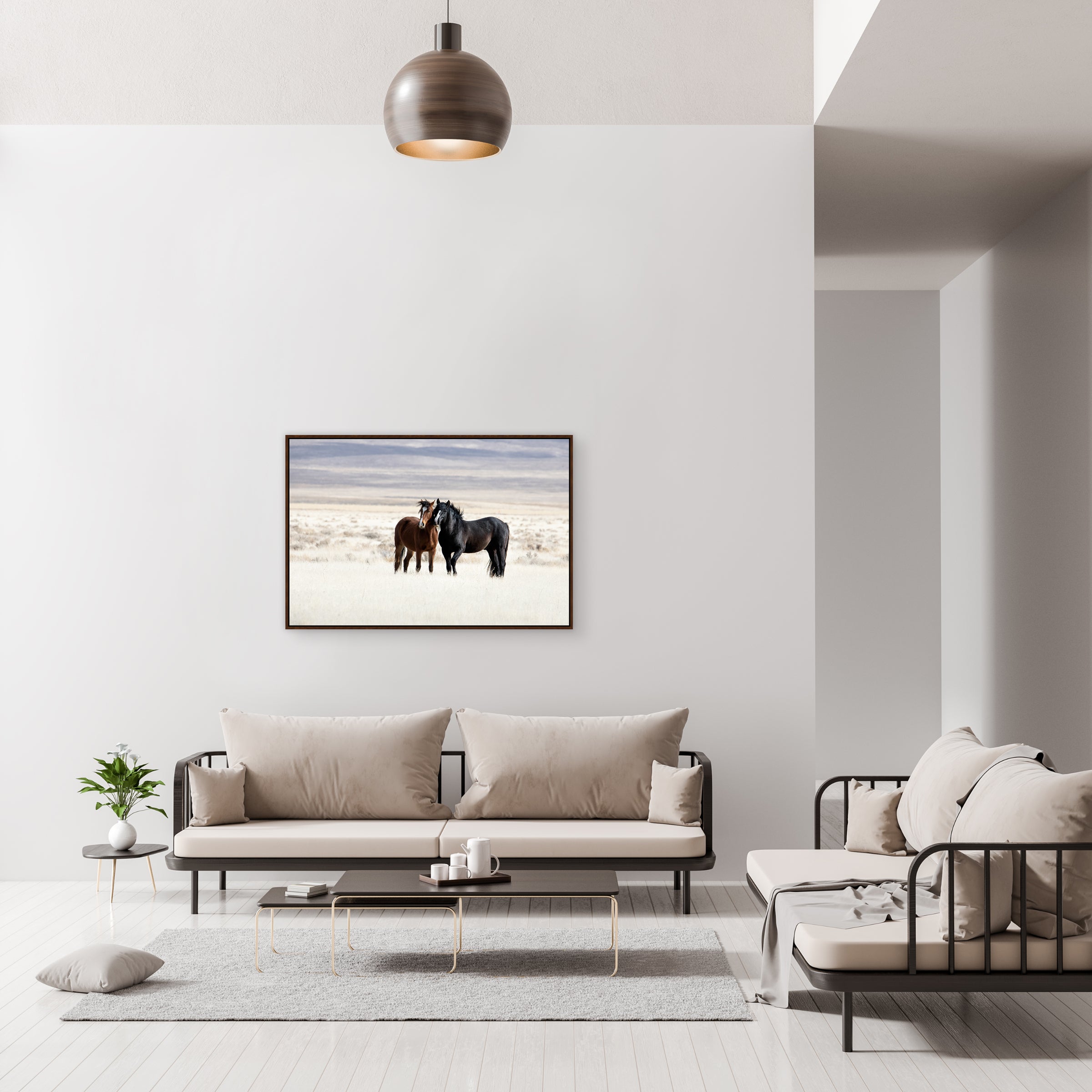 Modern living room with a sofa, chair, and framed picture of two horses on the wall - Your Western Decor