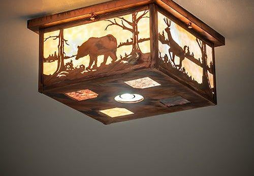 A square ceiling light fixture with a rustic wood frame and warm glowing glass panels featuring silhouettes of a bear and trees, mounted on a ceiling.