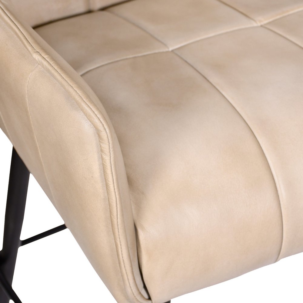 Close up of ivory leather on swivel counter stool