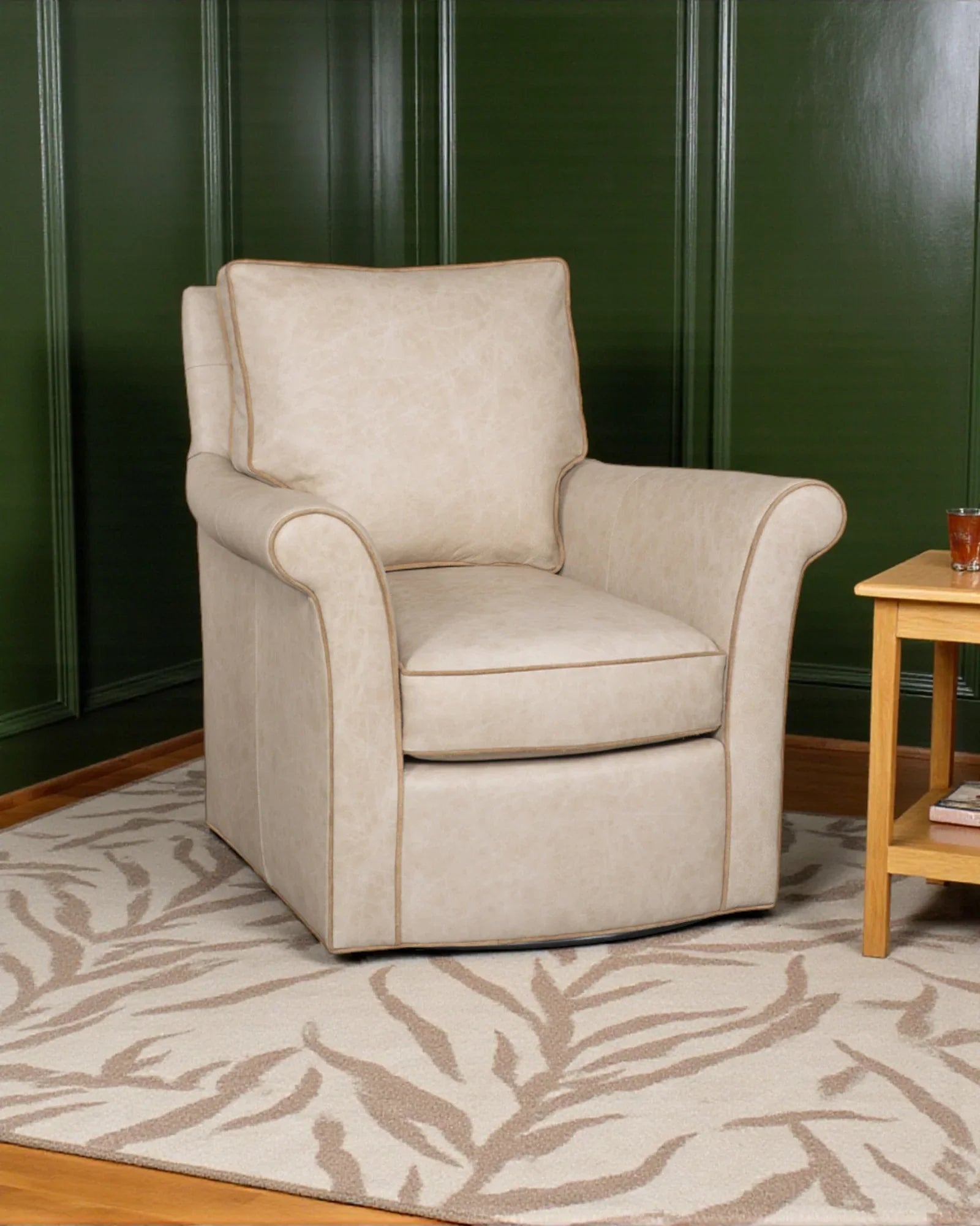 Beige armchair in a room with a green wall and wooden side table - Your Western Decor