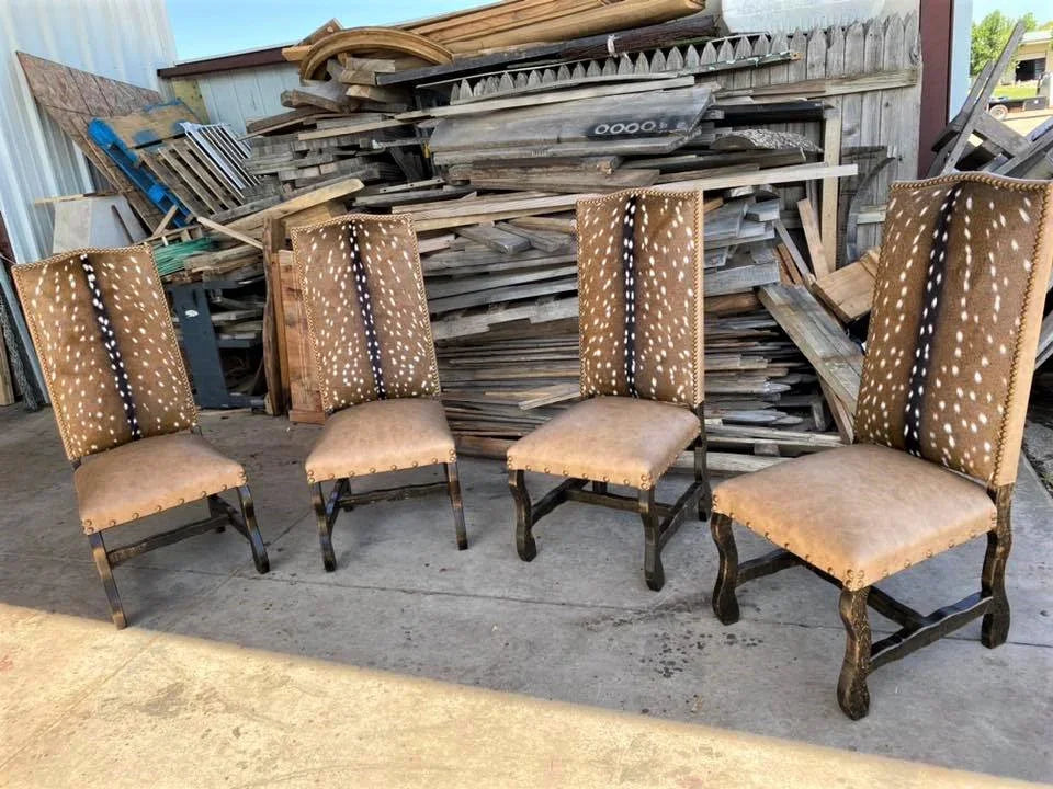 Four wooden chairs with upholstered seats and backrests in front of a pile of wooden planks - Your Western Decor