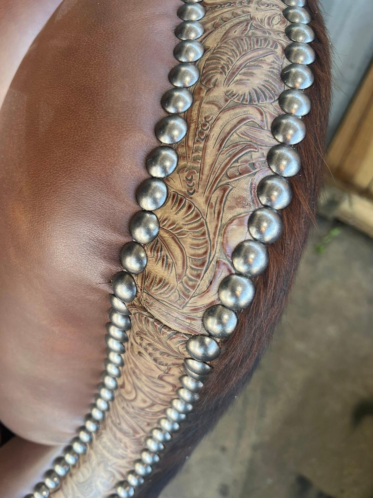 Detail nail and embossed leather trim on swivel glider chair - Your Western Decor