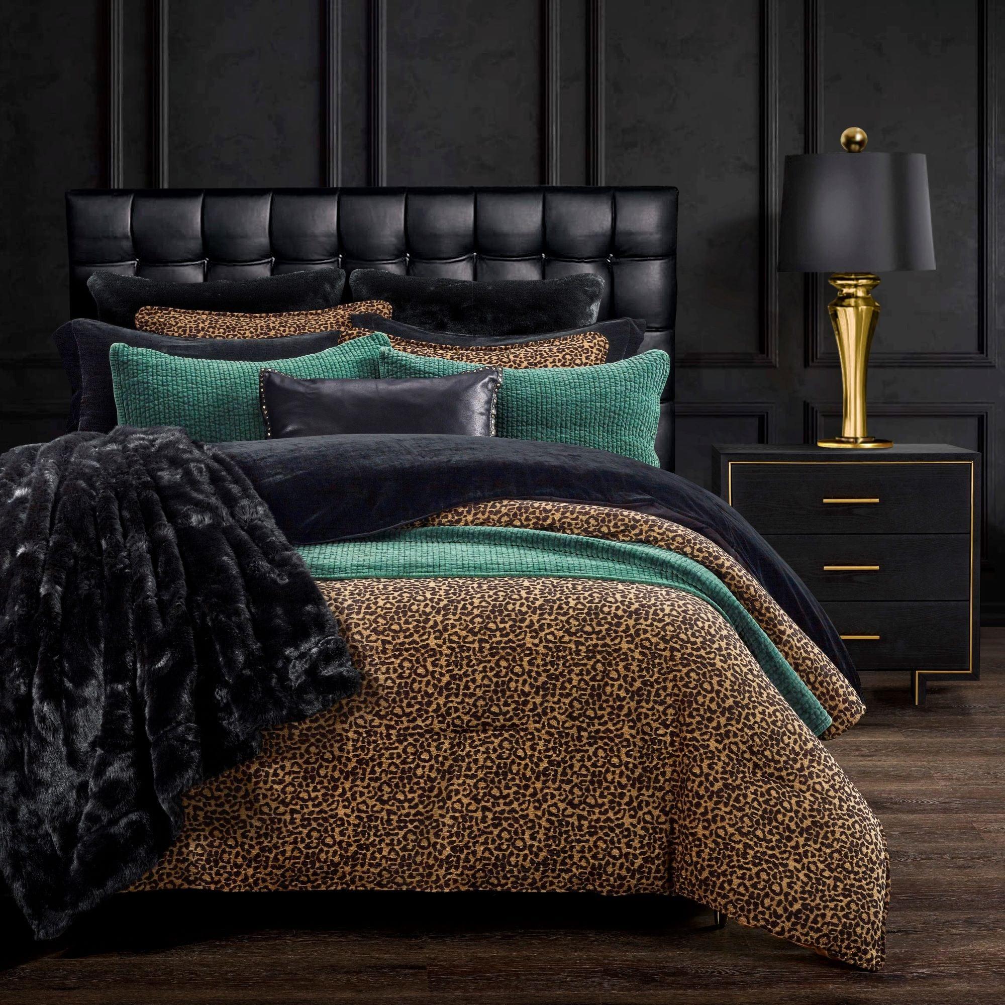 Bed with leopard print and solid color bedding in a darkly decorated room - Your Western Decor