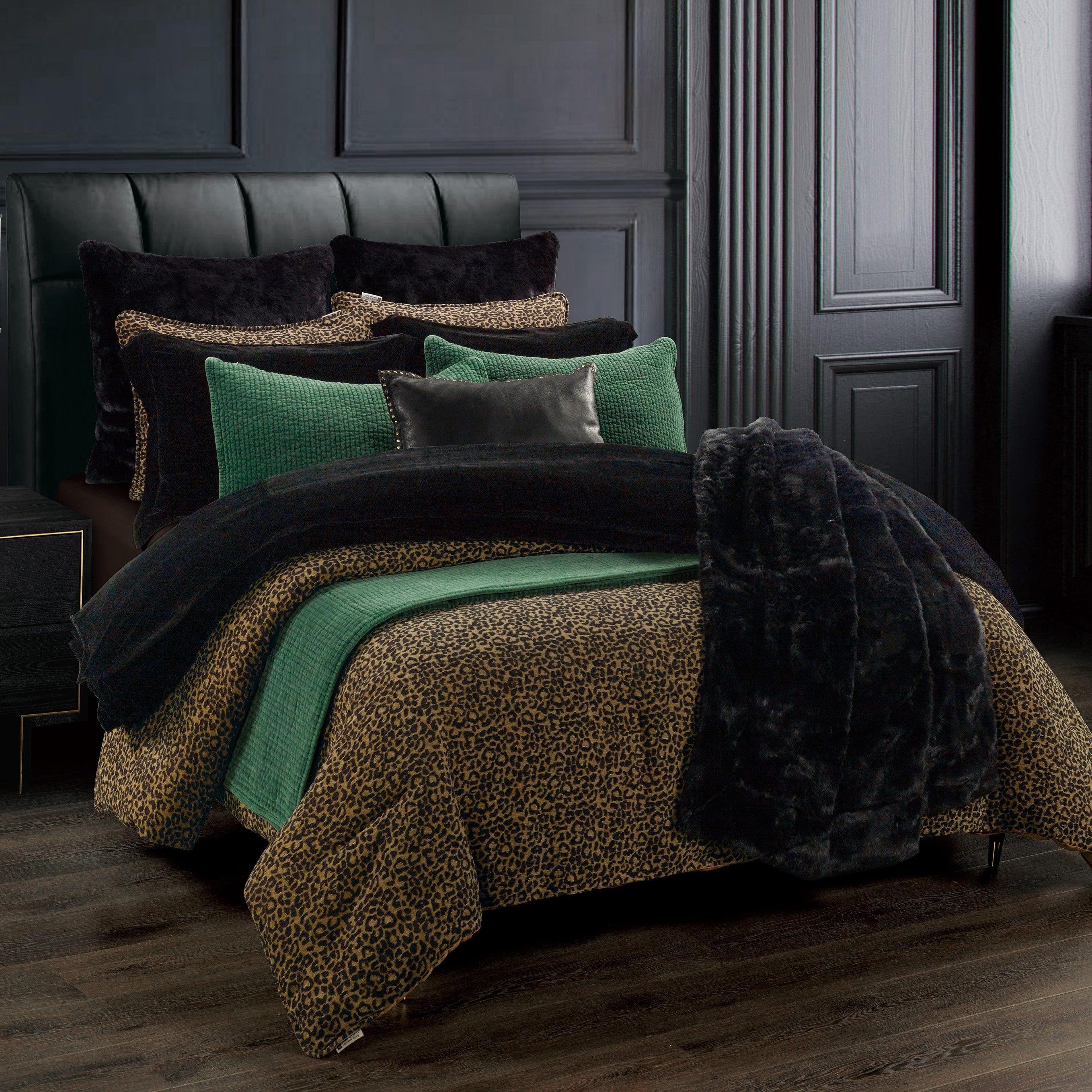 Bed with leopard print and green comforter in a darkly decorated room - Your Western Decor