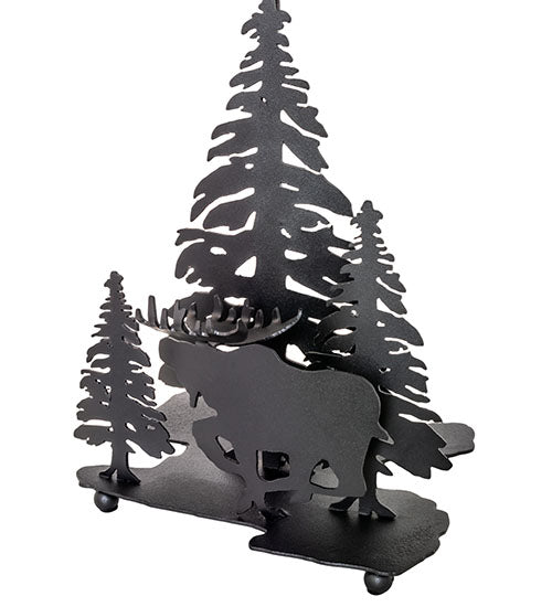 Close-up of textured black moose and pine tree silhouettes on rustic lamp base