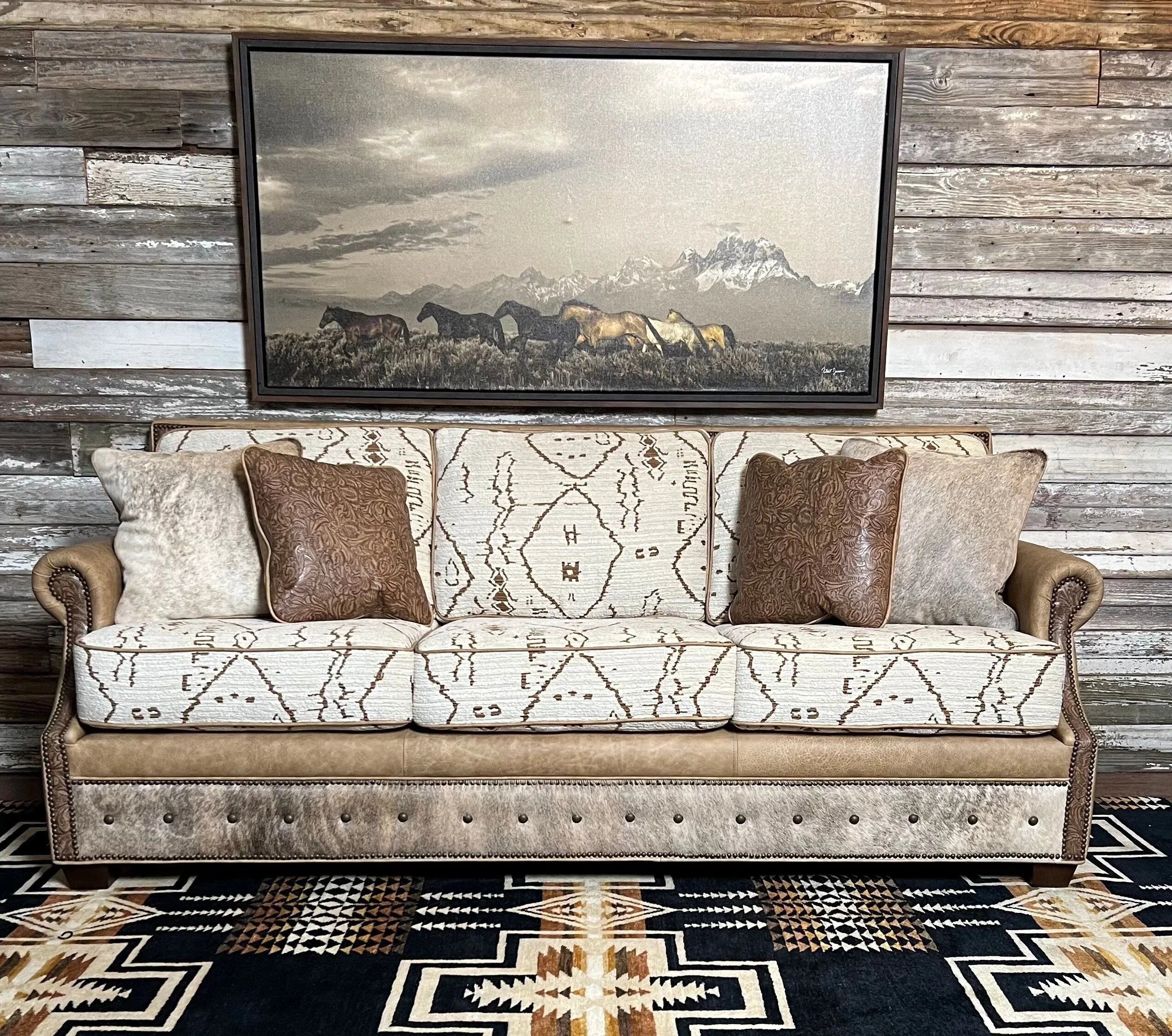 Southwestern Mesa fabric sofa with light brindle cowhide, smooth leather and embossed leather accents on Pendleton Harding Rug with horse art