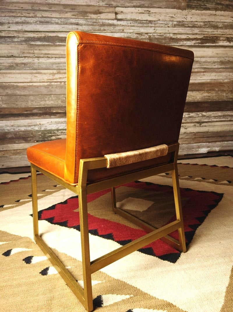 Caramel leather dining chair with brass metal frame and cowhide detail on back - Your Western Decor